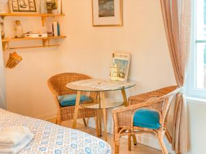 a room with a table and two chairs and a table at Clementines House Honfleur in Honfleur