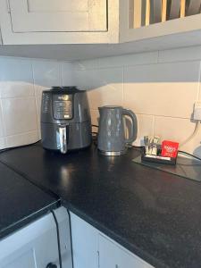 a toaster and coffee pot on a kitchen counter at Dream Cottage in Ballintober