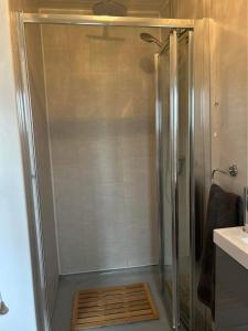 a shower with a glass door in a bathroom at Dream Cottage in Ballintober