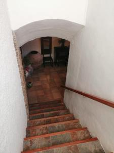 a stairway leading up to a room with a table at CAL BENAIGES in Tartareu