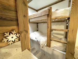 a couple of bunk beds in a room at New, terrasse, vue Mont Blanc in Chamonix-Mont-Blanc
