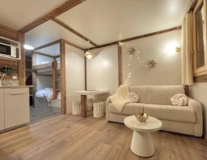 a living room with a couch and a table at New, terrasse, vue Mont Blanc in Chamonix