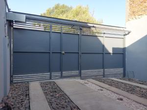 a black garage door on a building at La huerta in Guadalajara