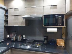 a kitchen with a stove and a microwave at La huerta in Guadalajara