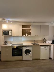 a kitchen with a washing machine and a dishwasher at Domaine du golf lacanau Piscine chauffée 3 chambres in Lacanau