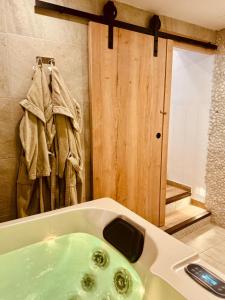 a bathroom with a tub with a green sink at Casa Olivia, Luxurious Village House with Sauna and Jacuzzi in Finestrat