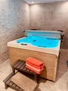 a bathroom with a hot tub with towels in it at Casa Olivia, Luxurious Village House with Sauna and Jacuzzi in Finestrat