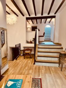 a living room with stairs and a table at Casa Olivia, Luxurious Village House with Sauna and Jacuzzi in Finestrat