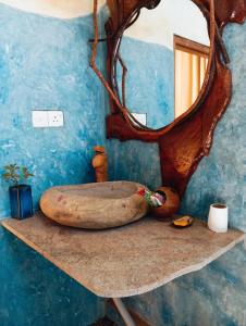 a bath tub sitting on a table with a mirror at SD3M ART GALLERY Villa in Dickwella