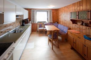 a kitchen with a table and a dining room at Zeiler Peter und Luisie in Waging am See