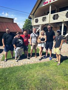 a group of people standing in front of a house at Casa de Greta in Svityazʼ