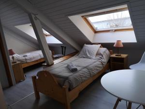 una camera mansardata con letto e finestra di La Fruitière d'Arith ad Arith