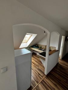een klein appartement met een kamer met een plafond en een raam bij Agroturystyka E.KO 
