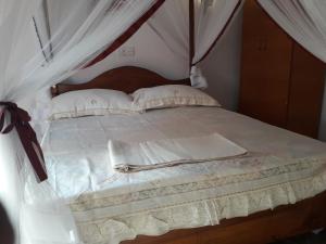 a large bed with white sheets and pillows at Harmonic villa in Weligama
