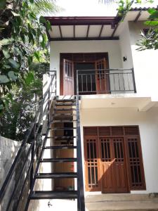 a staircase leading up to the front door of a house at Harmonic villa in Weligama