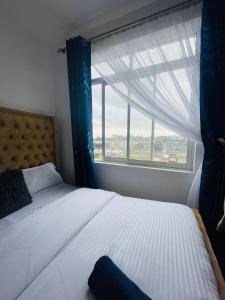 a bedroom with a bed with a large window at Classy two bedroom Airbnb with swimming pool in Kiambu