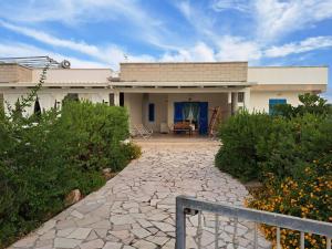 a house with a stone walkway in front of it at Villa Giulia in Ostuni
