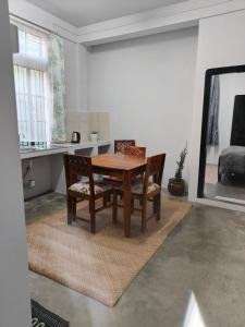 a dining room with a wooden table and two chairs at HeiJo's Homestay in Jowai