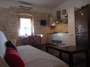 a kitchen with a bed and a table in a room at Apartment Alba in Funtana