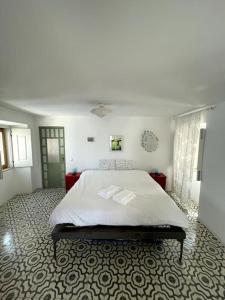 a bedroom with a large bed in a room at Zen House in Sines