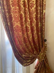 a curtain in a room next to a window at Residenza Carlandi Tivoli in Tivoli