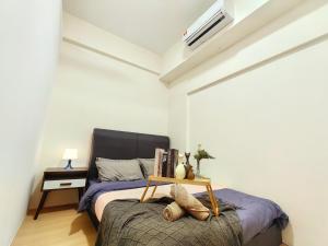 a bedroom with a bed with a table on it at G5 1-8Pax Cozy 2Room Sunway Medical 3Q beds TV WIFI in Kampong Penaga