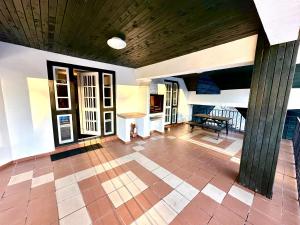 a living room with a wooden ceiling and a tile floor at Pine Peak in Predeal