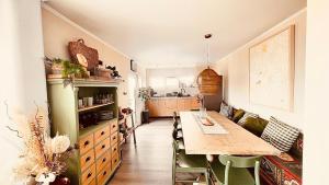 a kitchen with a long table in a room at Maison du golf in Costinesti