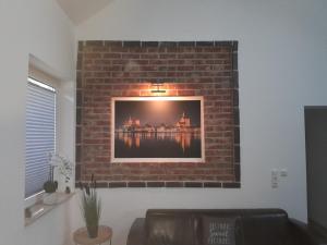 a brick wall with a picture of a building at Ferienhaus im Grünen in Wendorf