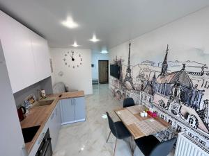 une cuisine avec une table et un dessin mural dans l'établissement ApartPlus Truskavets - Затишні апартаменти, à Trouskavets