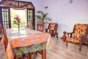 a dining room with a table and chairs at DiNi Galle in Galle