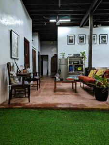 a living room with couches and a table and grass at Villanueva House in Liliw