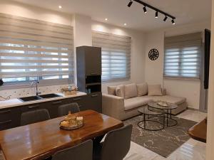 a kitchen and living room with a table and a couch at Iatrou city home in Volos