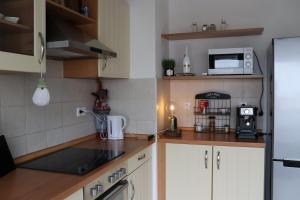 a kitchen with white cabinets and a microwave at Budapest Penthouse & View in Budapest