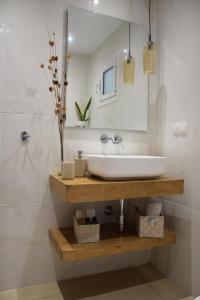 a bathroom with a sink and a mirror at Aliki Studios in Boukari