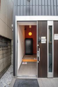 an entrance to a building with a black door at Apartment Sanjo in Nara