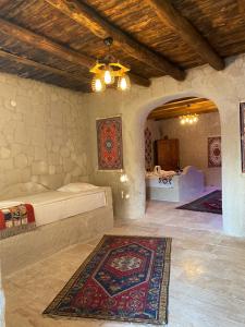 a bedroom with a bed and a rug on the floor at Seven Rock Cave Hotel in Göreme