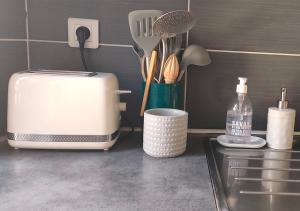 a kitchen counter with a toaster and utensils at Les Vitraux de Saint Rémi in Dieppe +15 photos