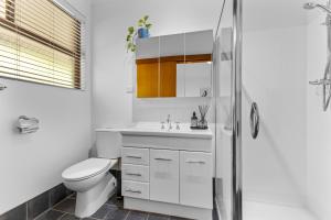 a bathroom with a toilet and a sink and a shower at Diamond Lake Escape in Collie