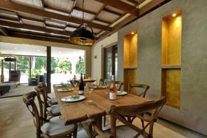 a dining room with a wooden table and chairs at Corfu Dream Holidays Villas in Achílleion