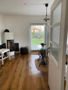 a living room with a table and a window at Erholung am Deich in Glückstadt