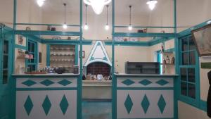 a kitchen with blue and green cabinets and a counter at Mesa Vrisi in Karpathos