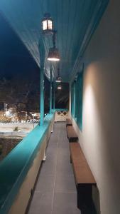 a row of benches on a balcony at night at Mesa Vrisi in Karpathos