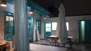 a room with a table and a white umbrella at Mesa Vrisi in Karpathos