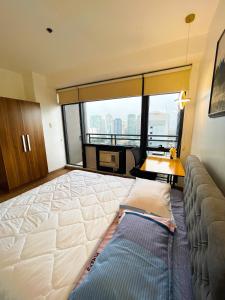 a hotel room with a large bed and a couch at Luxury 2BR Penthouse in Gramercy, Makati in Manila