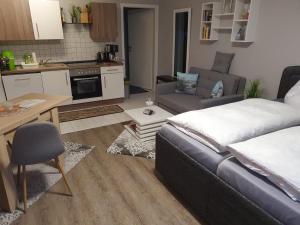a living room with a bed and a kitchen at Ferienwohnung Luna in Stralsund