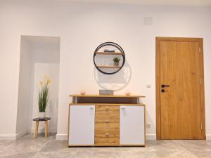 a mirror on a wall next to a wooden door at Apartment in Purkersdorf bei WienTop 3 in Purkersdorf