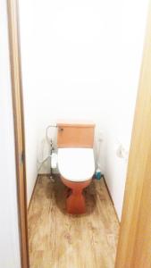 a toilet in a bathroom with a wooden floor at Hananogo Ikebukuro - Vacation STAY 16064v in Tokyo