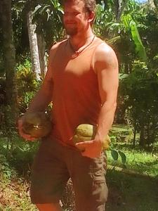 a man in a tank top standing in the woods at Hiriketiya Green Hill Home in Dickwella