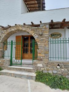 an entrance to a building with an arch doorway at Siroco's Rooms And Studios in Parikia